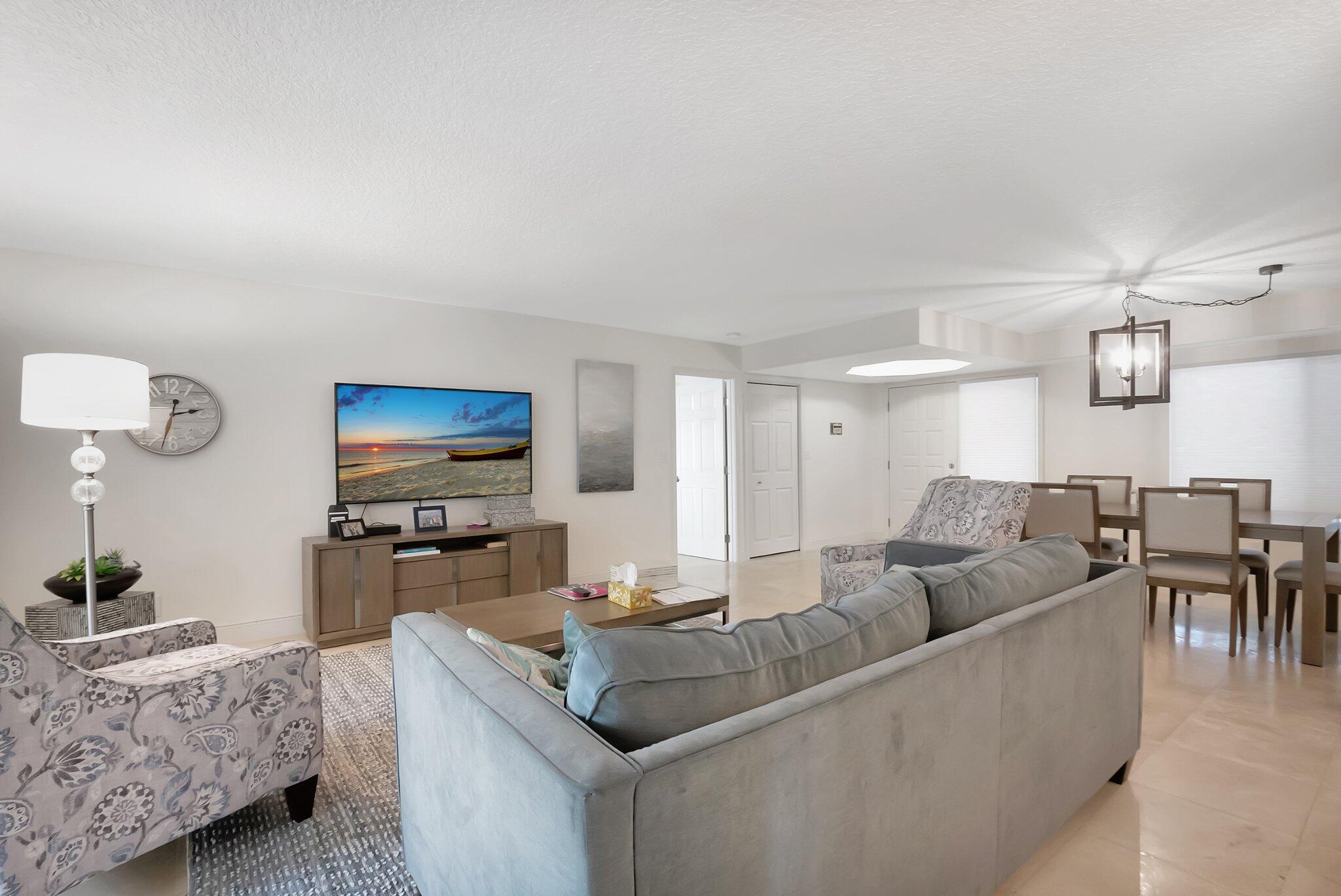 7370 Orangewood Lane, Unit 107 Boca Raton, FL 33433 - Photo 10 of 78 a living room with furniture and a flat screen tv