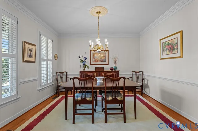 a view of a dining room with furniture and chandelier