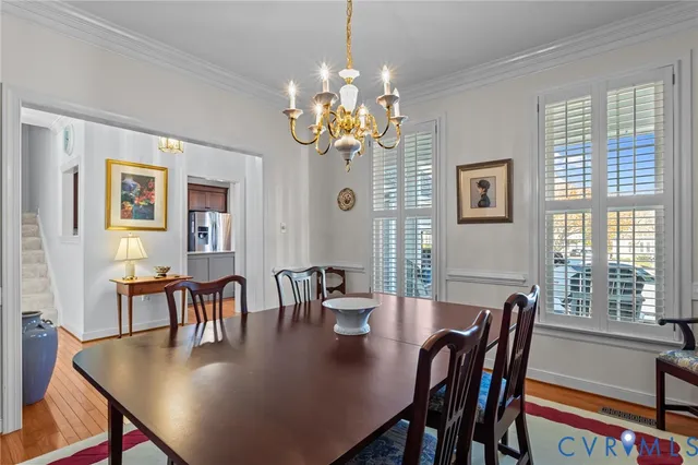a view of a dining room with furniture and chandelier