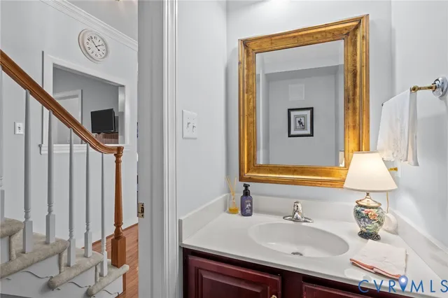 a bathroom with a sink vanity and mirror