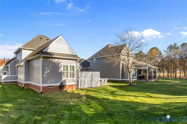 a backyard of a house with table and chairs
