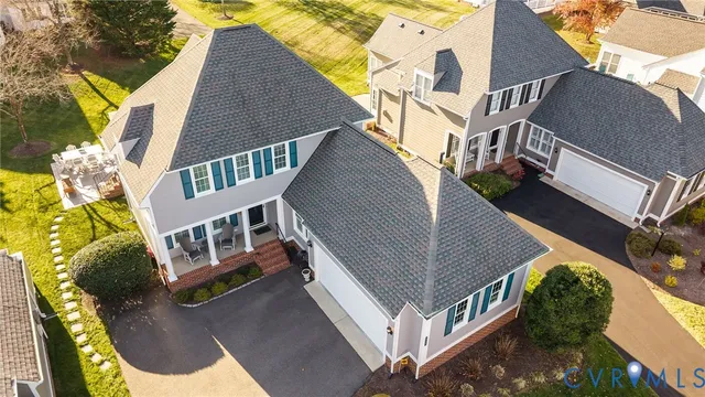 an aerial view of a house with swimming pool and patio