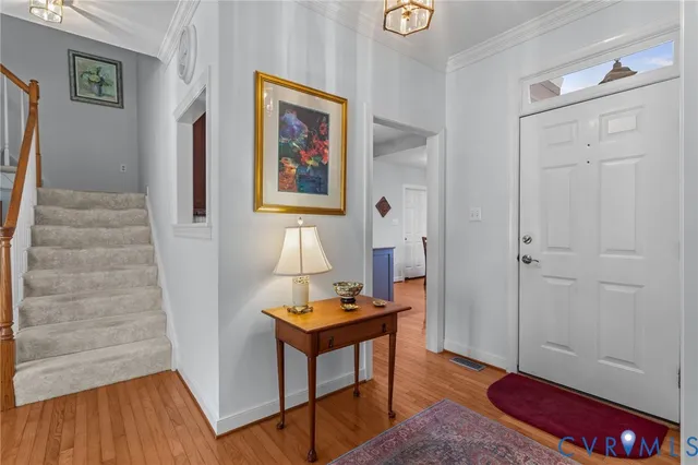 a view of a hallway with wooden floor and furniture