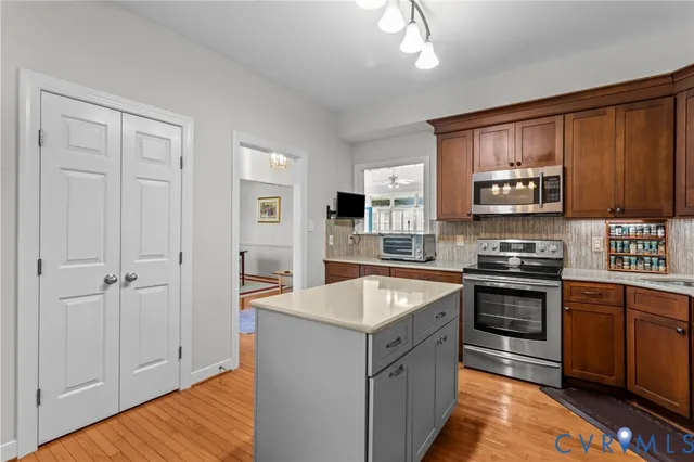 a kitchen with stainless steel appliances granite countertop a stove and a sink