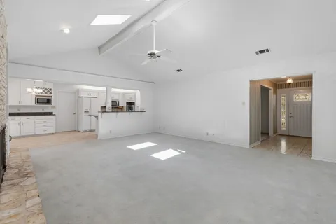 a kitchen with granite countertop white cabinets and stainless steel appliances