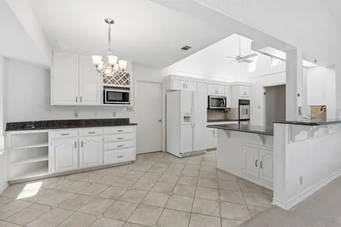 a kitchen with stainless steel appliances a refrigerator and a stove