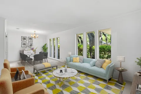 a living room with furniture fireplace and windows