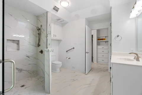 a bathroom with a toilet sink and mirror