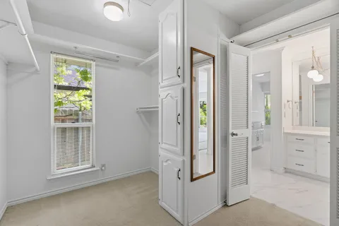 a bathroom with a granite countertop sink a toilet a mirror a bathtub and shower