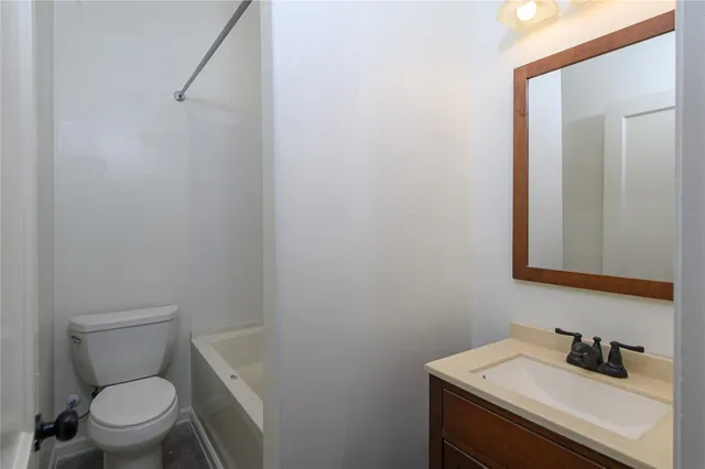 a bathroom with a sink a toilet and mirror