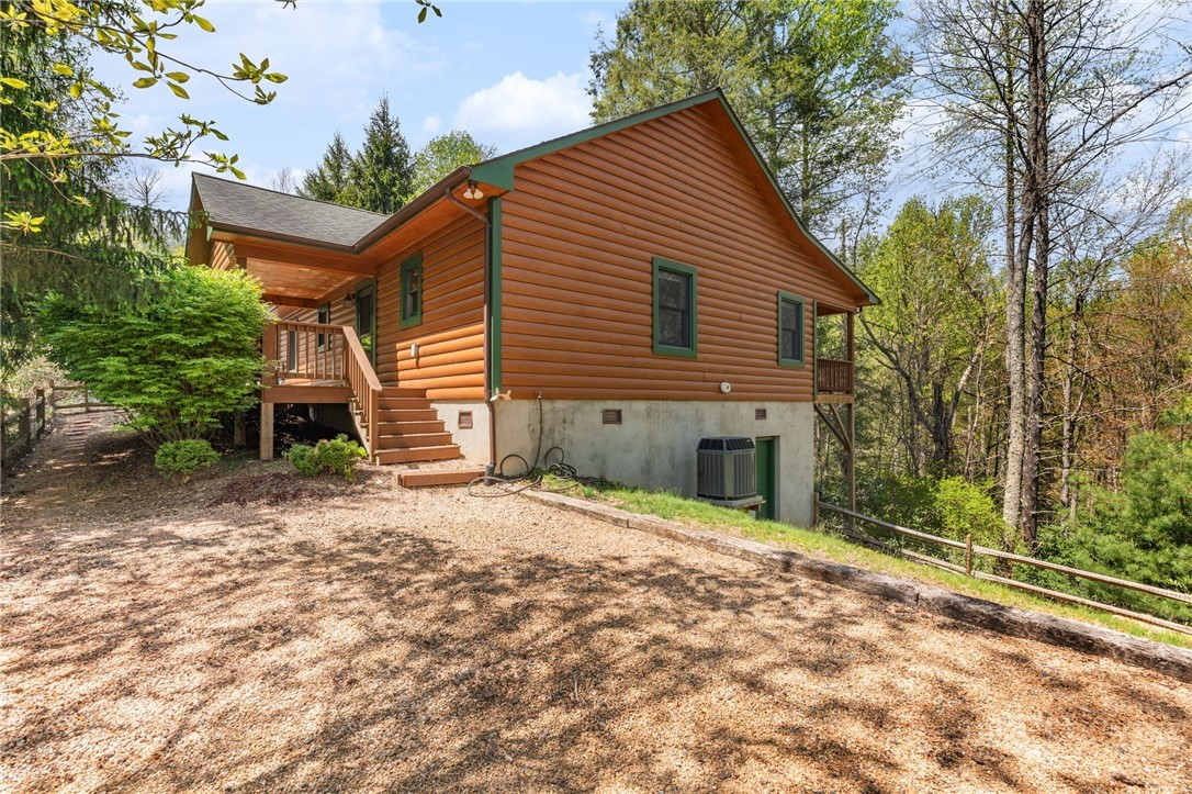148 Woodby Ridge Road Vilas, NC 28692 - Photo 2 of 33 a front view of a house with a yard and garage