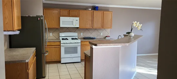 a kitchen with a sink and a refrigerator