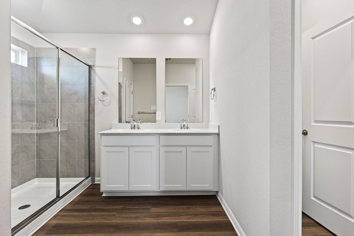 145 Honey Bee Road Jarrell, TX 76537 - Photo 15 of 27 a bathroom with a shower sink and mirror