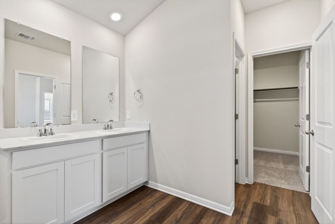 145 Honey Bee Road Jarrell, TX 76537 - Photo 17 of 27 a bathroom with a double vanity sink and mirror