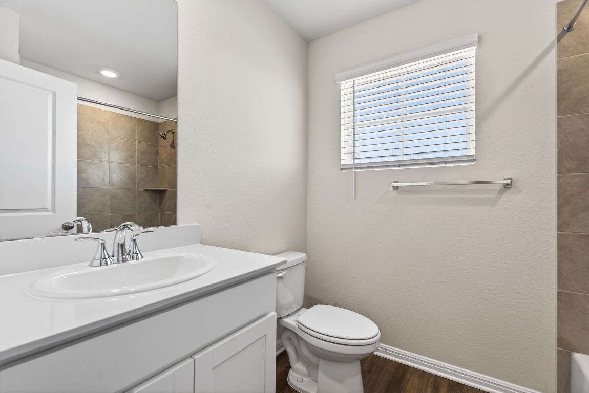 145 Honey Bee Road Jarrell, TX 76537 - Photo 22 of 27 a bathroom with a sink toilet and a mirror