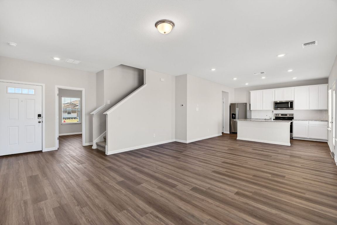145 Honey Bee Road Jarrell, TX 76537 - Photo 3 of 27 a view of kitchen with furniture and wooden floor