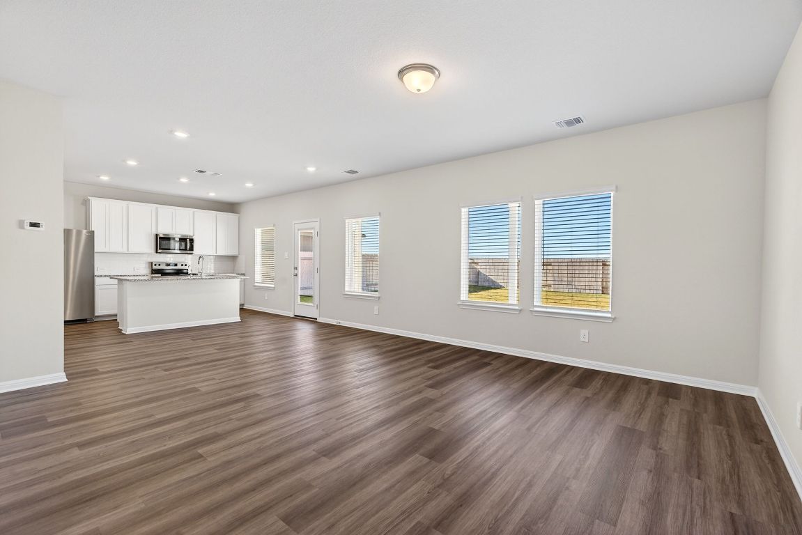 145 Honey Bee Road Jarrell, TX 76537 - Photo 5 of 27 a view of a kitchen with a sink and a stove top oven