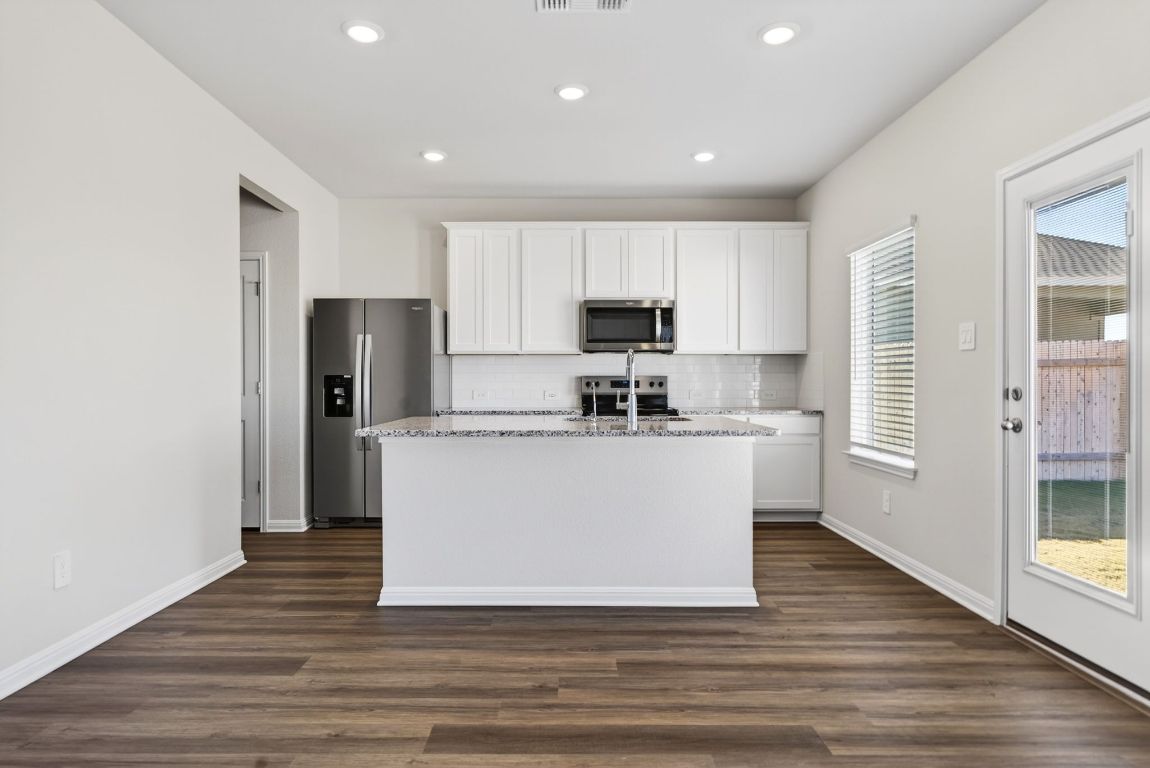 145 Honey Bee Road Jarrell, TX 76537 - Photo 6 of 27 a view living room with stainless steel appliances wooden floors kitchen view and window