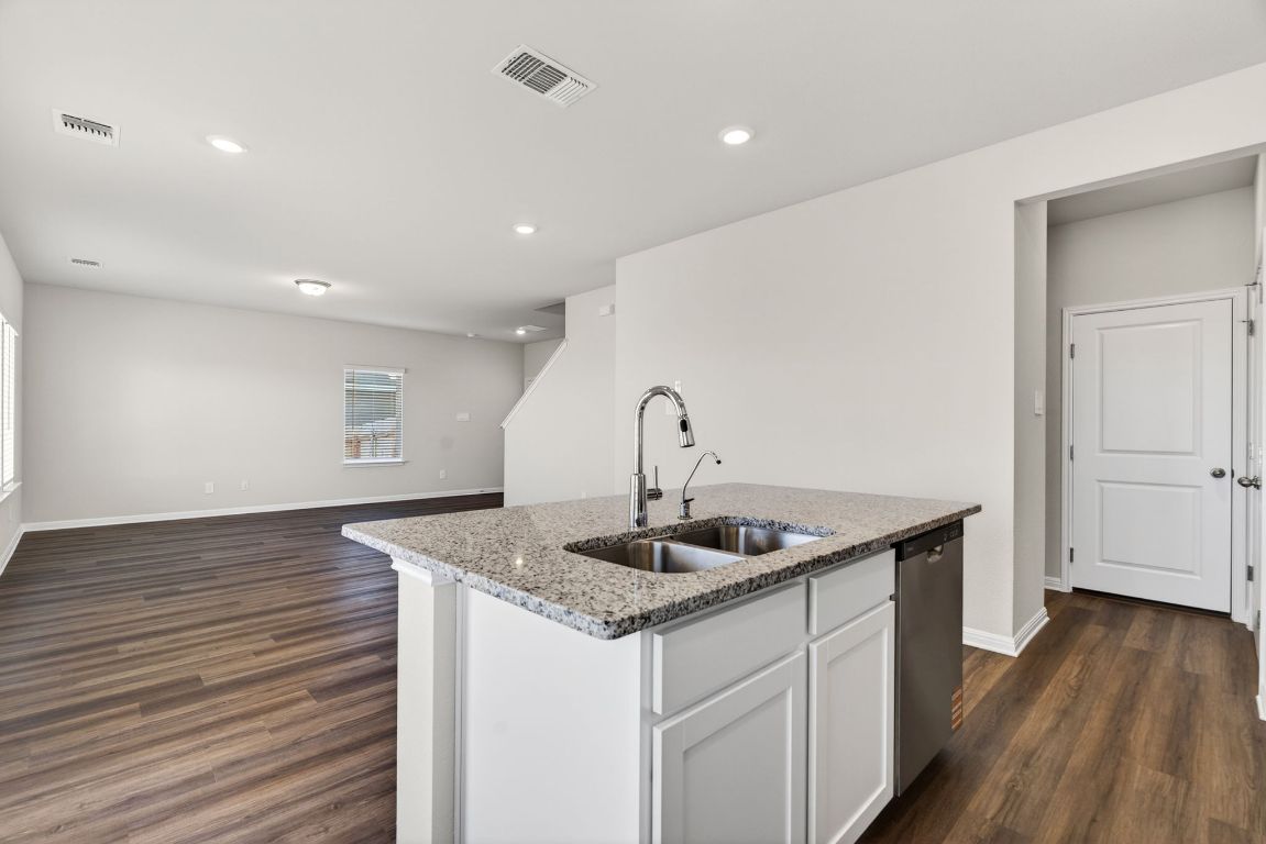 145 Honey Bee Road Jarrell, TX 76537 - Photo 27 of 27 a kitchen with a sink and wooden floor