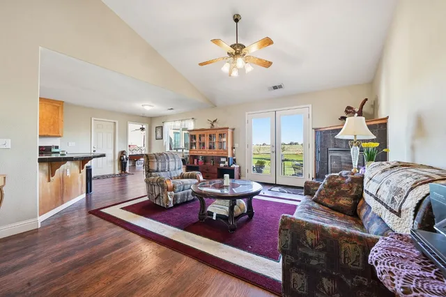 a kitchen with stainless steel appliances granite countertop wooden cabinets a sink and dishwasher with wooden floor