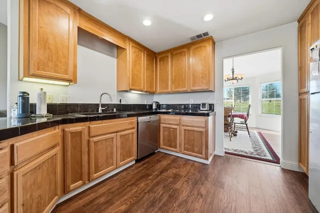a view of a dining room with furniture and chandelier