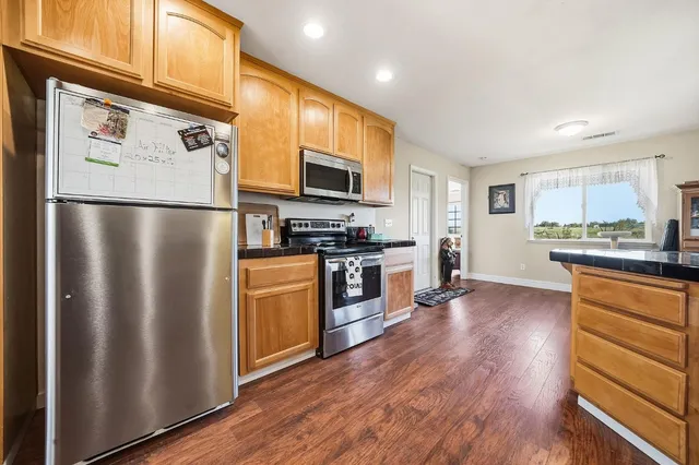 a bed sitting in a bedroom next to a window