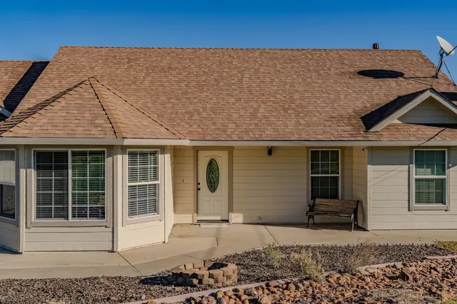 a backyard of a house with yard and outdoor seating