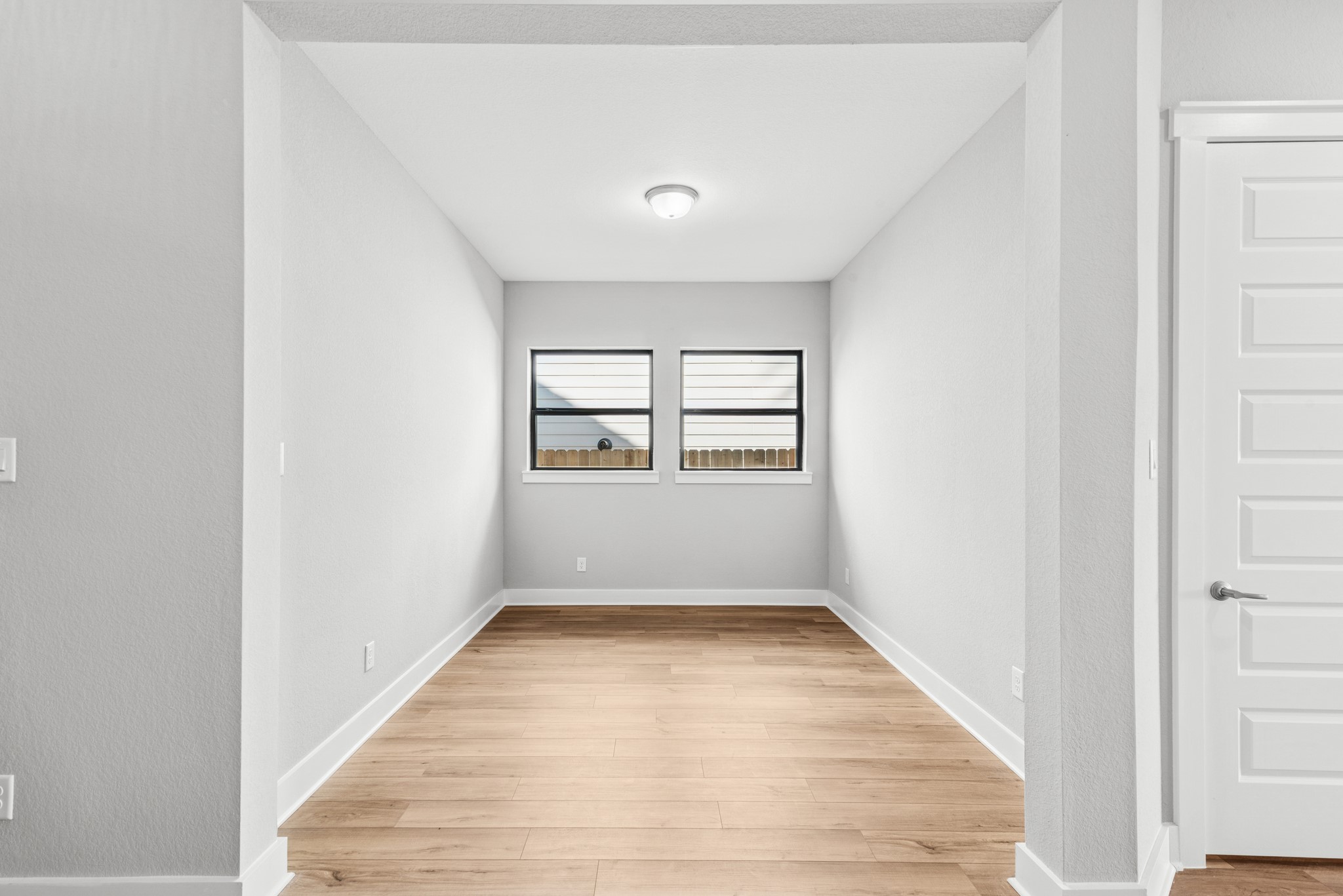 16142 Rita Road Conroe, TX 77302 - Photo 16 of 48 an empty room with wooden floor and windows