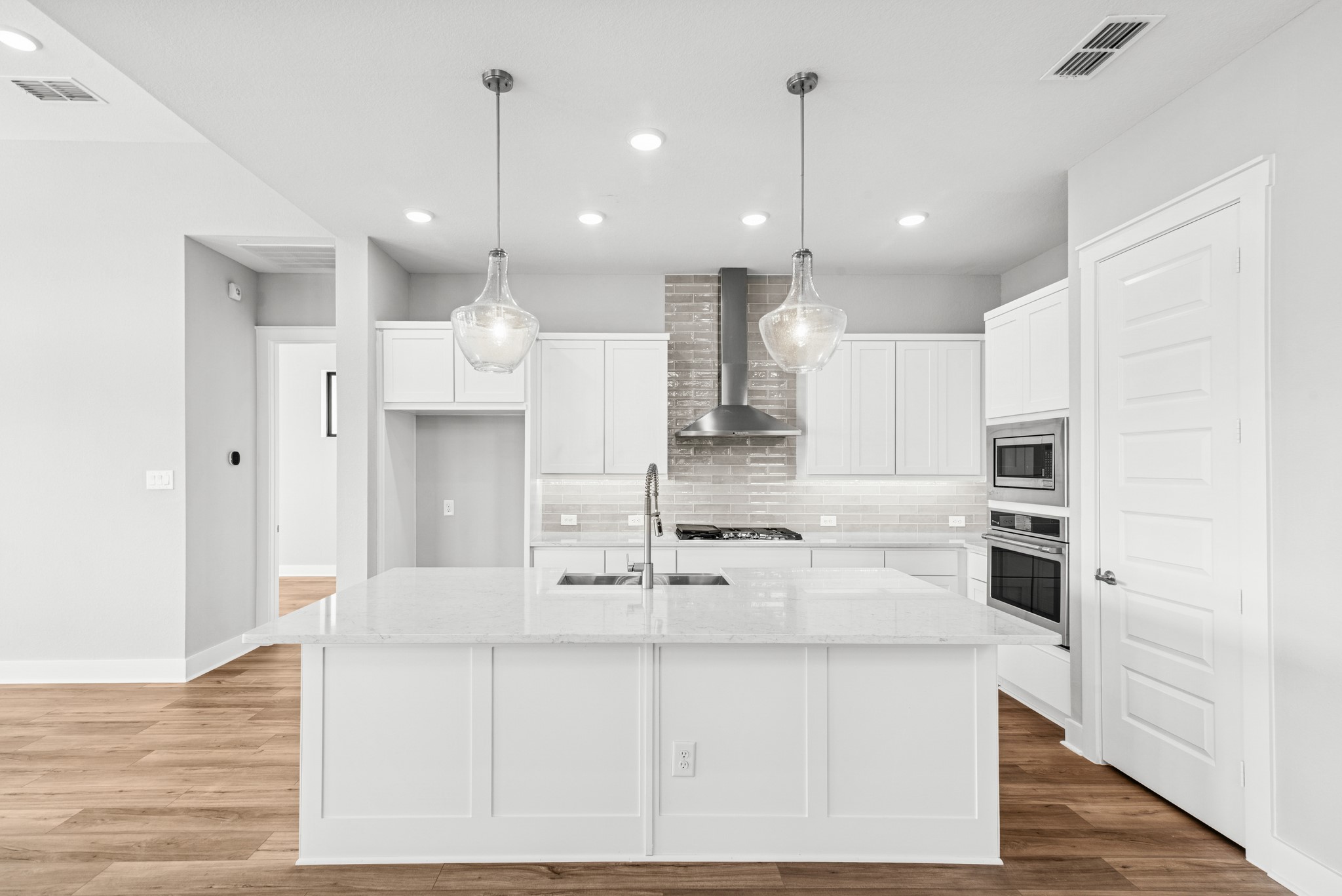 16142 Rita Road Conroe, TX 77302 - Photo 19 of 48 a large kitchen with kitchen island white cabinets and stainless steel appliances