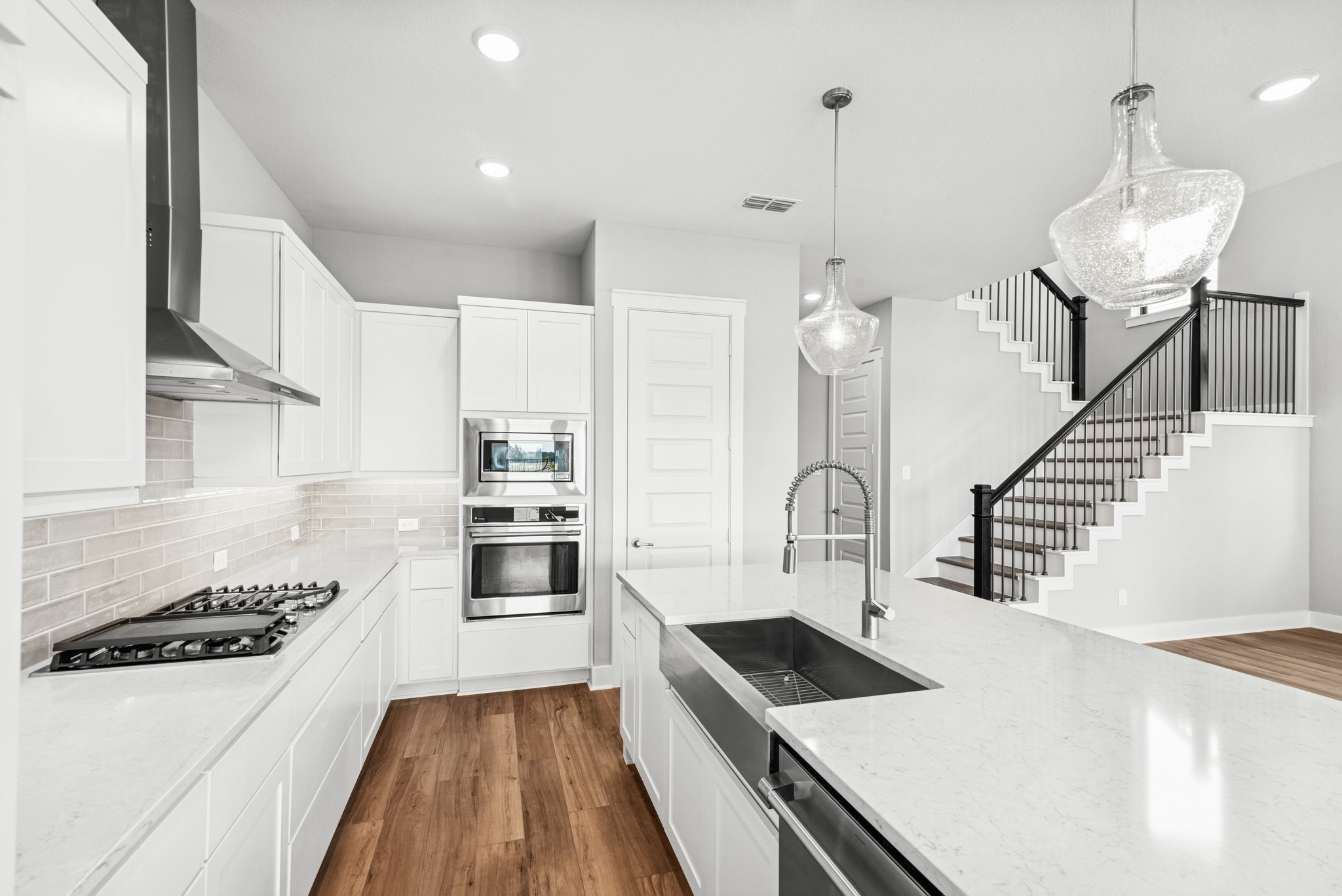 16142 Rita Road Conroe, TX 77302 - Photo 21 of 48 a kitchen with a stove a sink and a refrigerator