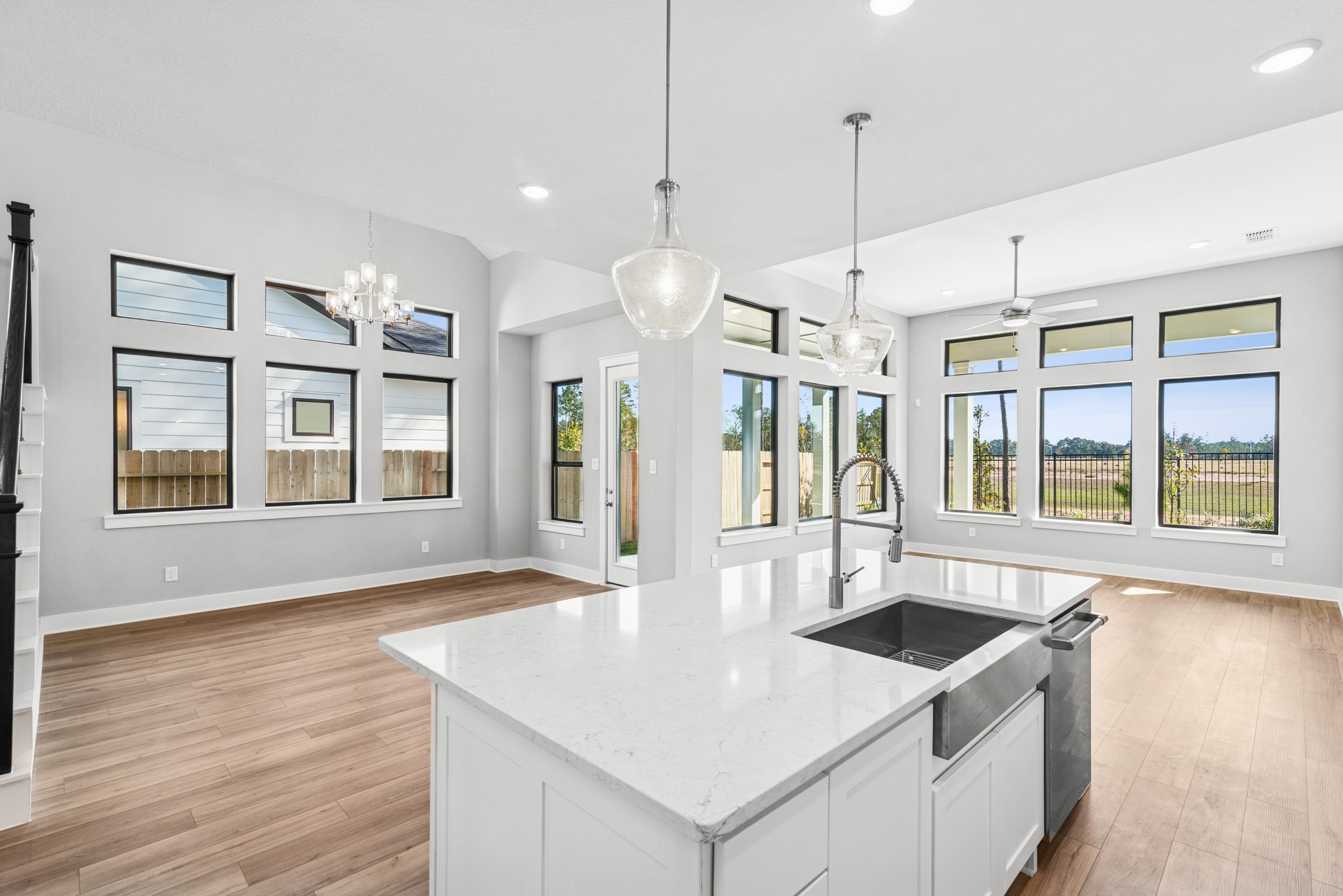 16142 Rita Road Conroe, TX 77302 - Photo 23 of 48 a kitchen that has a sink a stove and a wooden floor