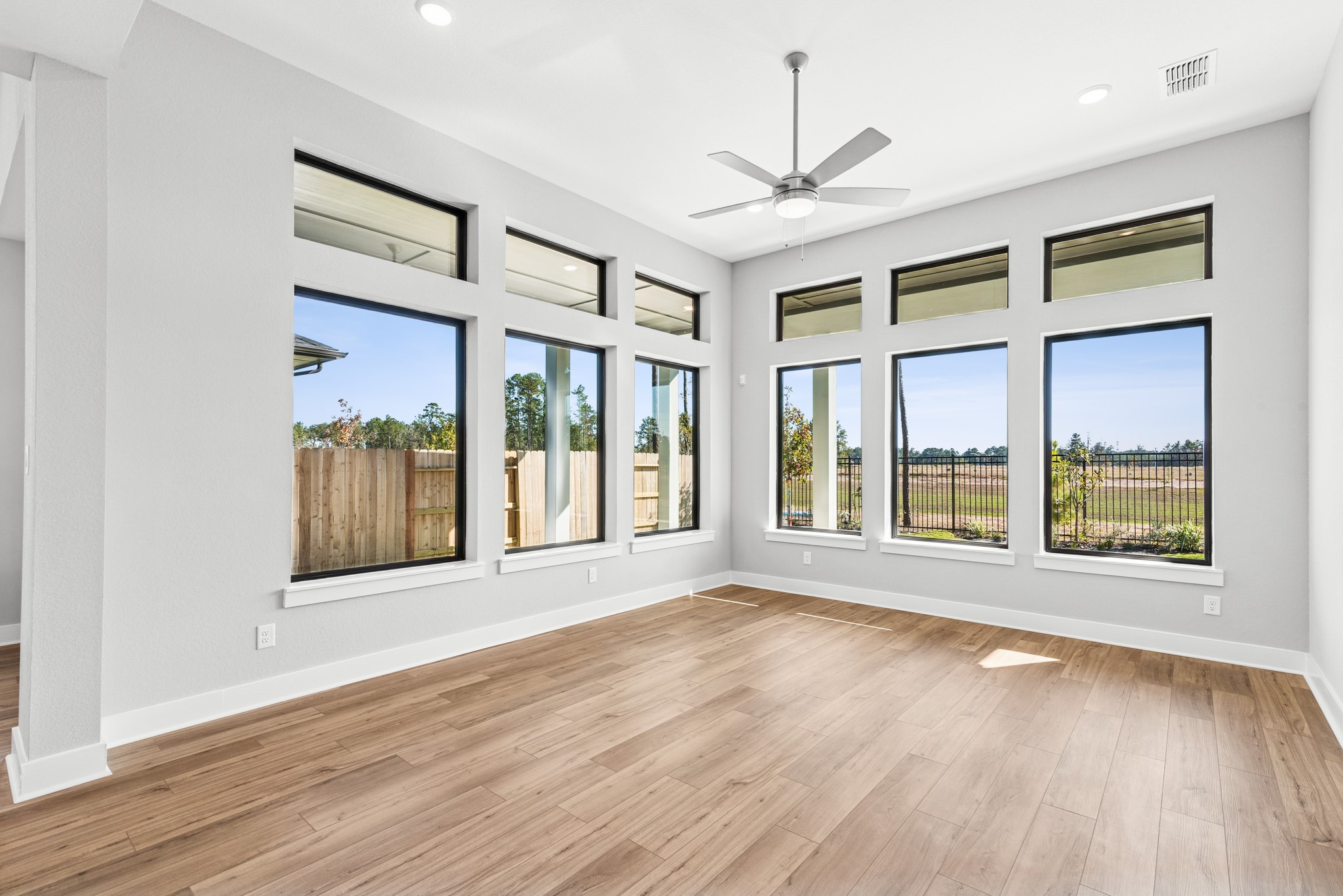 16142 Rita Road Conroe, TX 77302 - Photo 25 of 48 a view of an empty room with a window and wooden floor