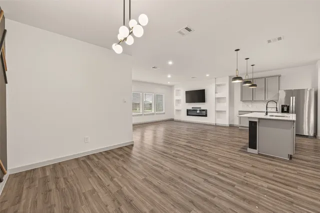 a view of kitchen with microwave a refrigerator and microwave