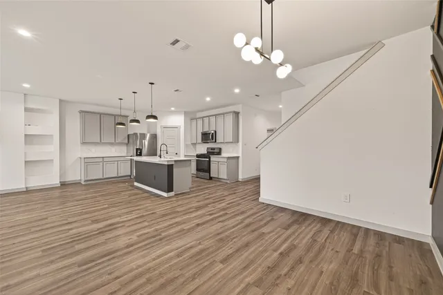 a view of kitchen with granite countertop cabinets and wooden floor