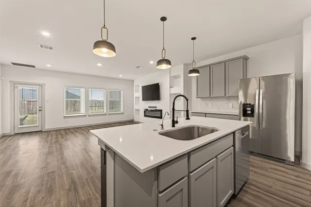 a kitchen with sink cabinets and wooden floor
