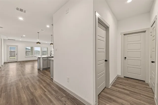 a view of a kitchen with wooden floor