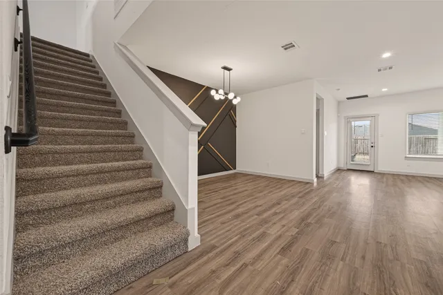 a view of entryway and hall with wooden floor