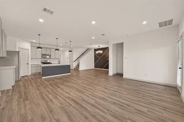 a view of kitchen with refrigerator and window