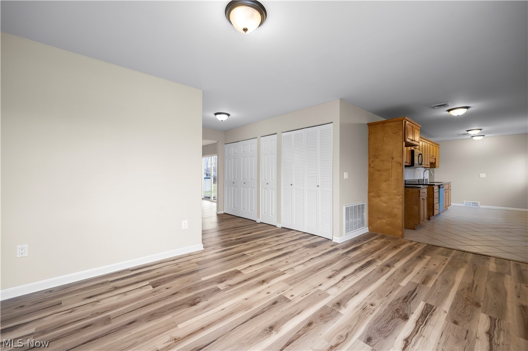 12452 Island Road Grafton, OH 44044 - Photo 5 of 39 Unfurnished living room featuring light wood-style floors and baseboards