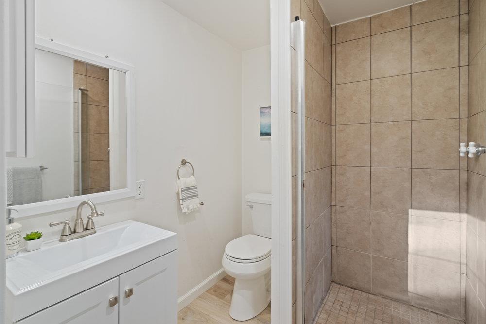 19 Jolley Way Scotts Valley, CA 95066 - Photo 30 of 56 a bathroom with a toilet a sink a mirror and vanity