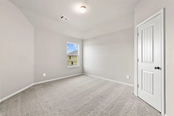 an empty room with windows and closet