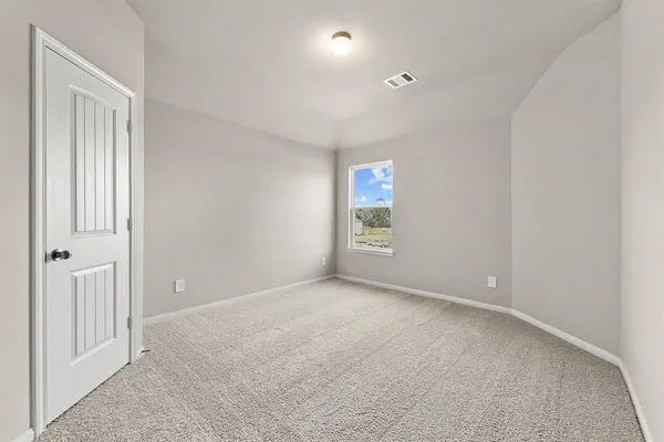 an empty room with windows and closet
