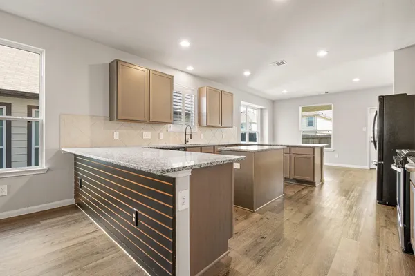 a kitchen with a sink stove and refrigerator