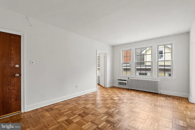 a view of an empty room and a window