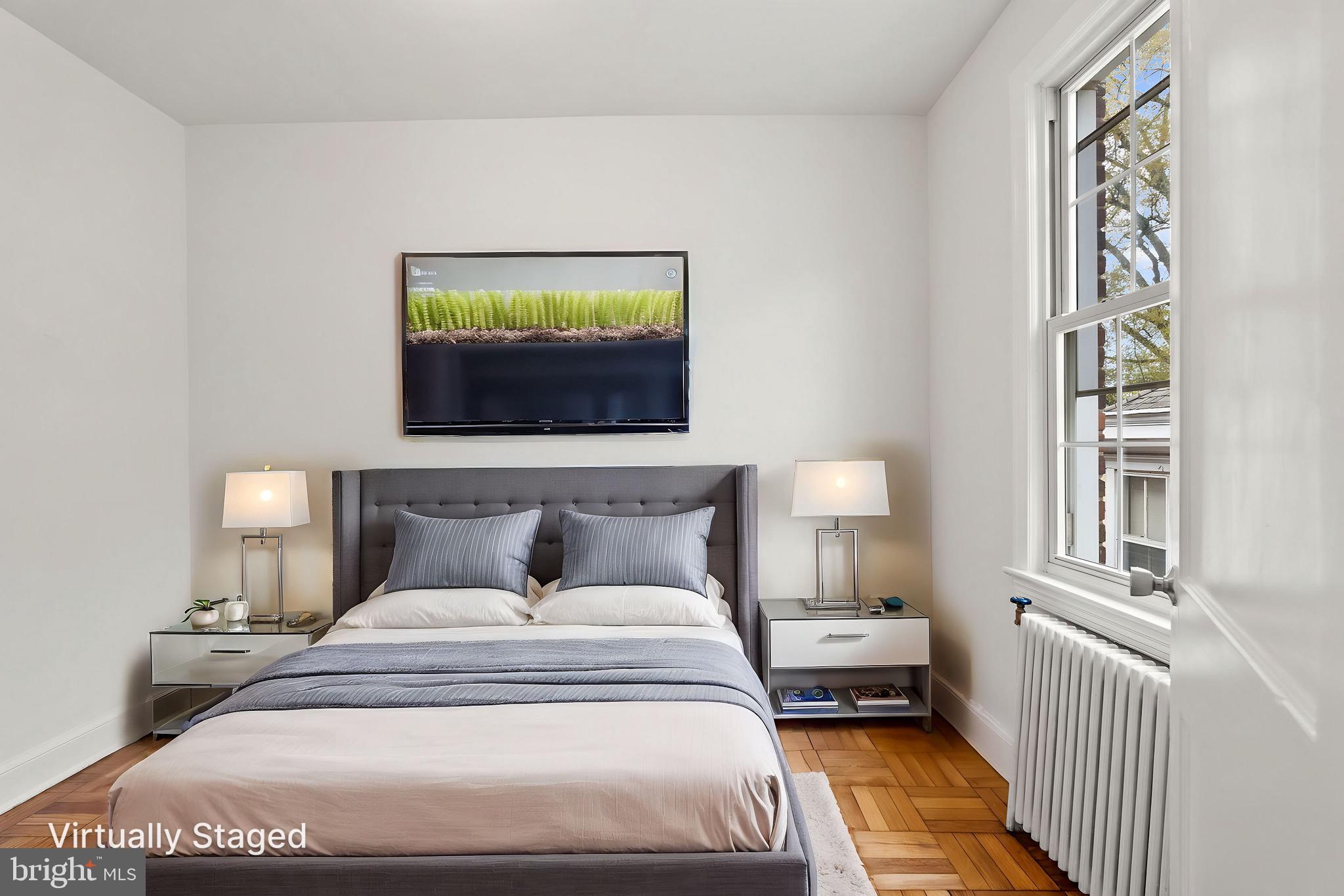 4491 MacArthur Boulevard Northwest, Unit 303 Washington, DC 20007 - Photo 15 of 37 a bedroom with a bed and a window