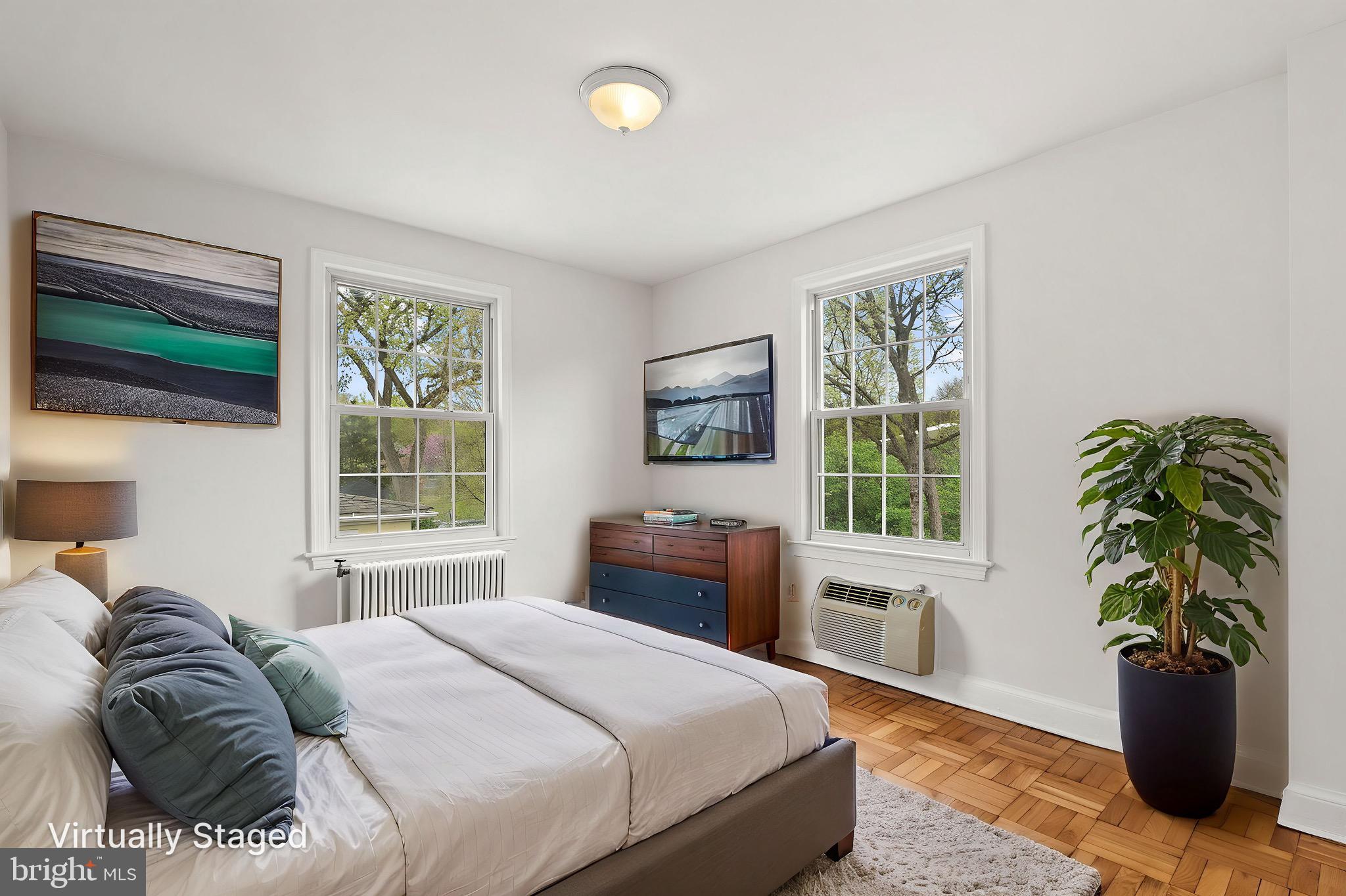 4491 MacArthur Boulevard Northwest, Unit 303 Washington, DC 20007 - Photo 19 of 37 a bedroom with a bed and a window