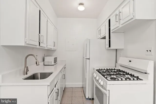 a kitchen with a stove and a refrigerator