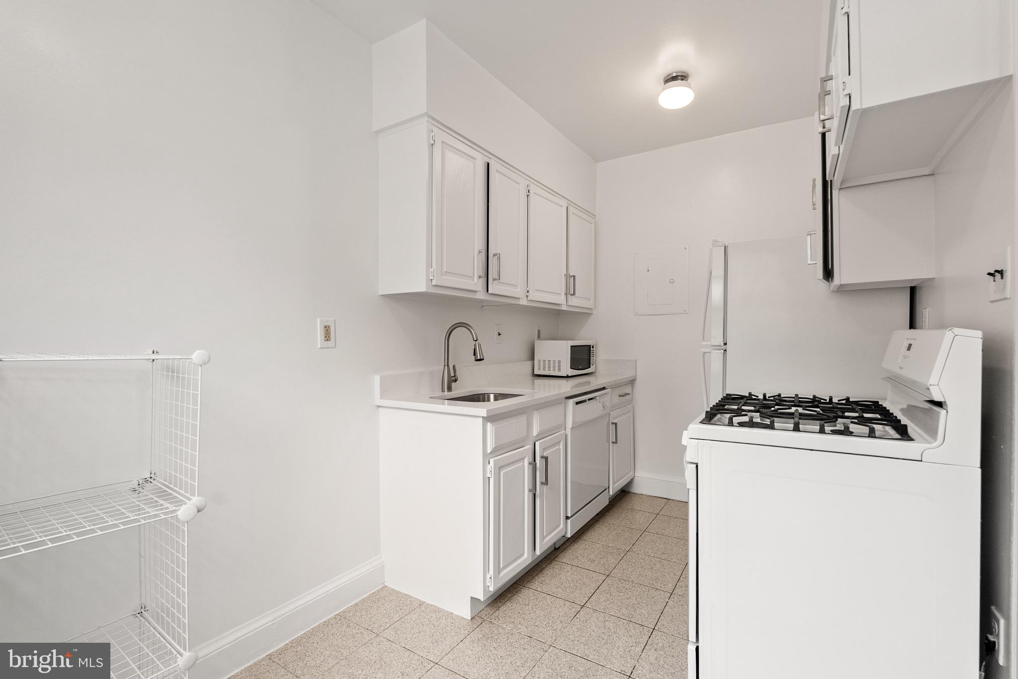 4491 MacArthur Boulevard Northwest, Unit 303 Washington, DC 20007 - Photo 8 of 37 a kitchen with a stove and a refrigerator