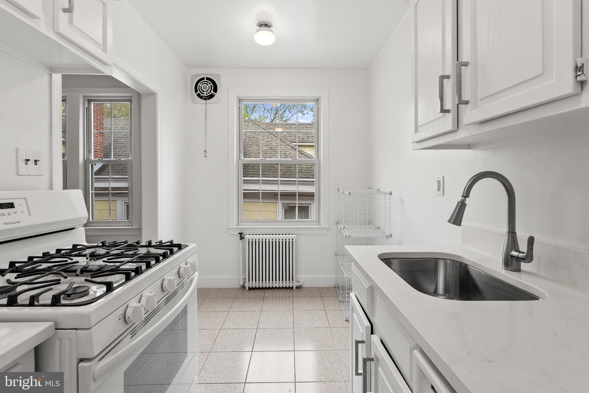 4491 MacArthur Boulevard Northwest, Unit 303 Washington, DC 20007 - Photo 10 of 37 a kitchen with sink a stove and cabinets
