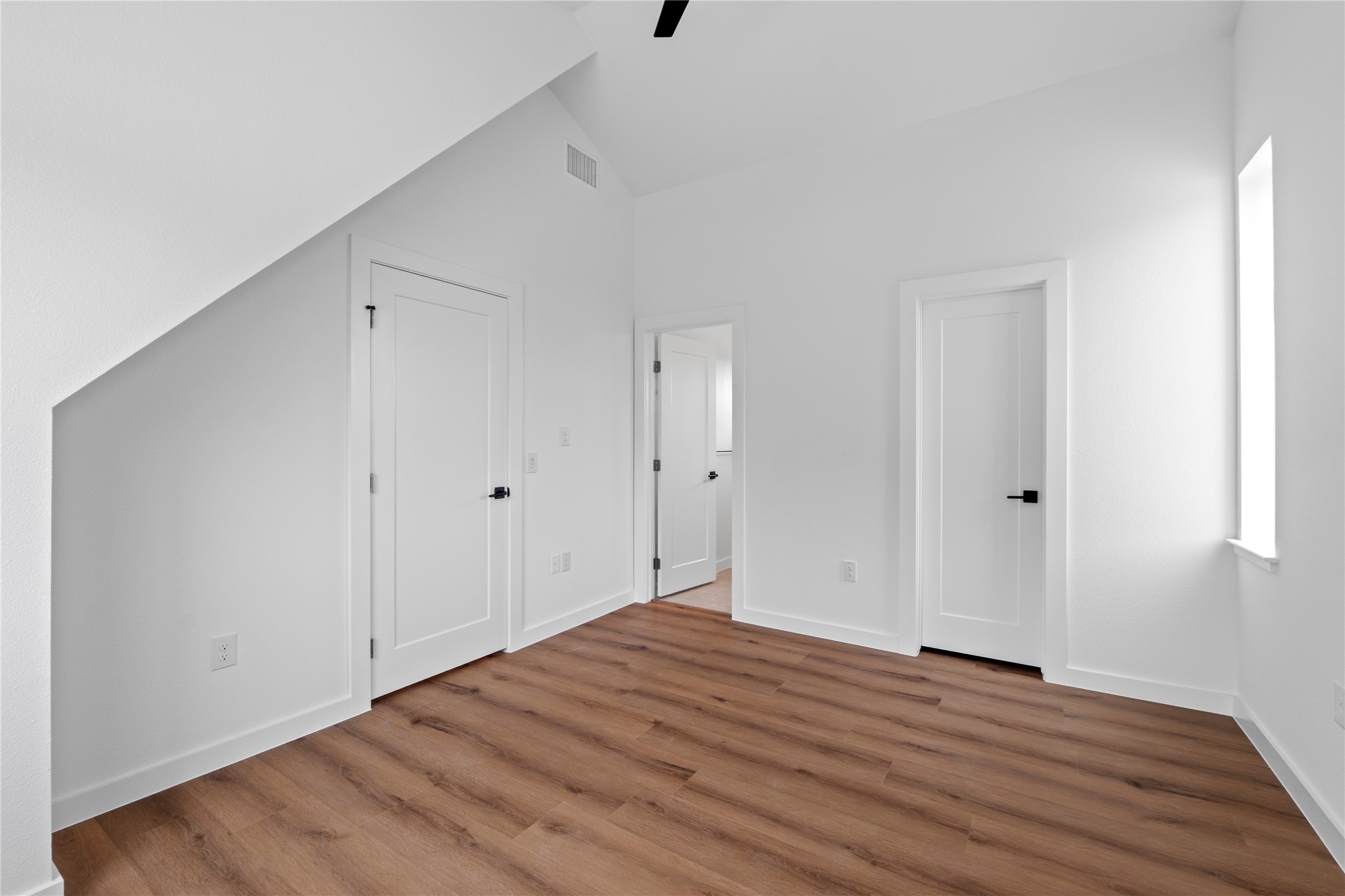 1406 Mason Avenue Austin, TX 78721 - Photo 10 of 36 MODEL HOME - REPRESENTATIVE PHOTO: Vaulted ceilings highlighting wood-finish flooring